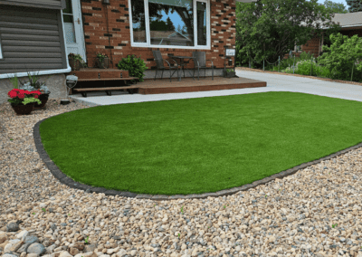 A backyard with a mix of real sod and artificial turf for a balanced look.